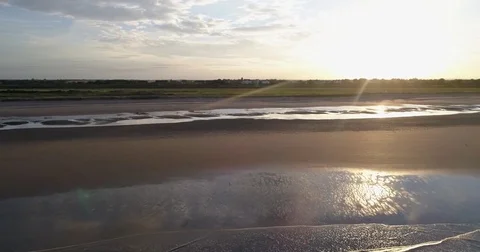 Aerial view of a sandy beach at sunset Stock Footage 77414696