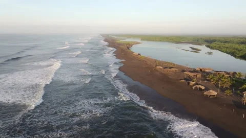 Aerial view of sandy beach with tranquil waves and huts, El Paredon, Guatemala. Stock Footage 279724506