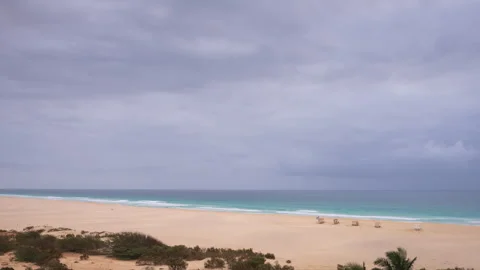 Aerial view of sandy beach turquoise ocean and background clouds Stock Footage 325446026
