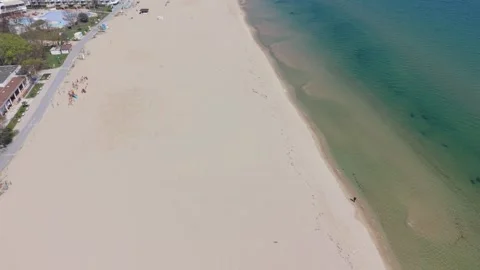 Aerial view of sandy beach with turquoise sea and resort Stock Footage 332247561