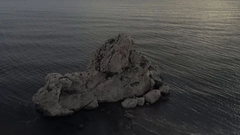 Aerial view of a sandy empty beach before sunset with a big nice rock. Stock Footage 119033640