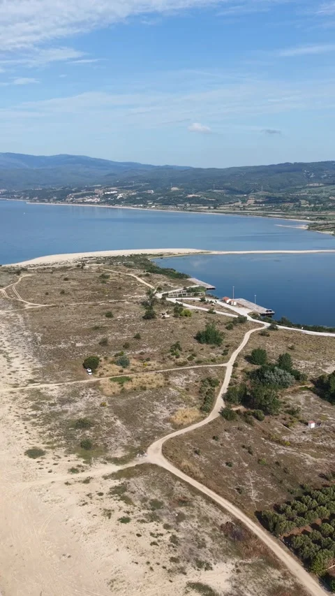 Aerial View of Sandy Peninsula, Pier and Coastal Lagoon in Greece 動画素材 342922684