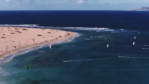Aerial view of sandy spit, dunes, and kites at Fuerteventura Stock Footage 326208575