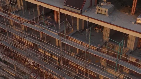 Aerial View: Scaffolding frames the emerging buildings of a residential complex Stock Footage 296076559