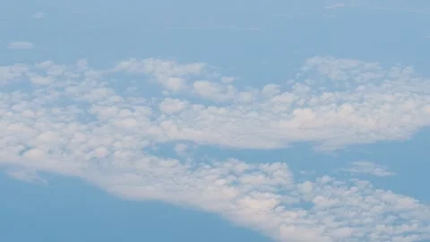 Aerial view of scattered clouds over a blue sky in slow motion 60fps Stock Footage 290094329