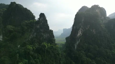 Aerial view scenery fly between beautiful mountains in untouched tropical jungle Stock Footage 235341834