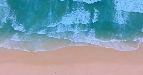 .aerial view scenery smooth waves in blue sea crashing on the pearl beach. Stock Footage 249094555