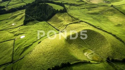 Aerial view on scenic landscape of volcano and green fields around it. Special Stock Photos