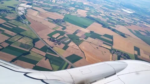 Aerial View of Scenic Patchwork Farmland and Fields from Airplane Window for Stock Footage 314750465