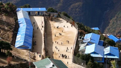 Aerial view of school building with playing children in Namche Bazar, Nepal Stock Footage 146023532