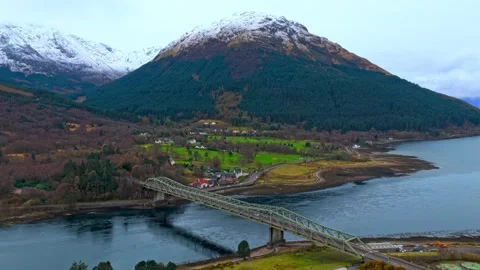 Aerial View of a Scottish Loch, Bridge and Snow-Capped Mountains Stock-Footage 341213832