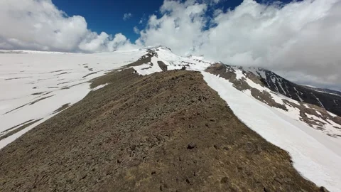 Aerial view of a scree ridge and snow slopes on Mount Aragats Stock Footage 343876702