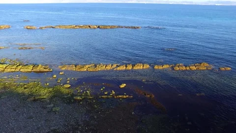 Aerial view of the sea side. Some rocks perfectly aligned on a narrow row 스톡 동영상 152862844