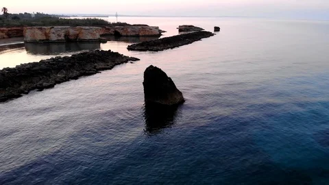 Aerial view of a sea stack in Cirica Bay, Sicily, Italy 4K Stock Footage 112121095