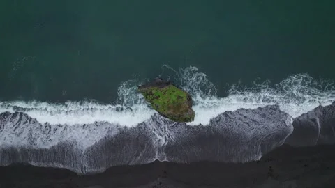 Aerial View Sea Stack Iceland Coast. Drone Flies Straight Up White Waves Stock Footage 258496112