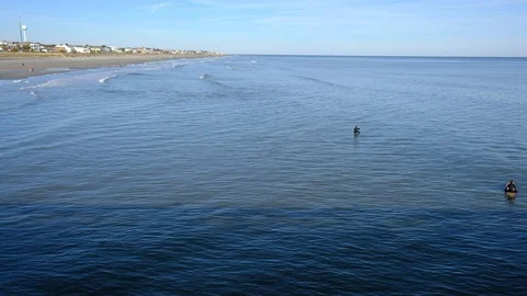 Aerial view of sea surface and surfers on it. Summer beach panoramic view Stock-Footage 101929285