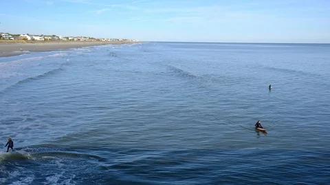 Aerial view of sea surface and surfers on it. Summer beach panoramic view Stock-Footage 102439237