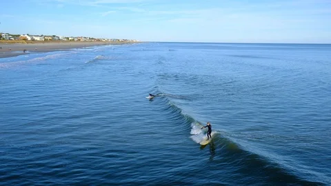 Aerial view of sea surface and surfers on it. Summer beach panoramic view Stock-Footage 102439357