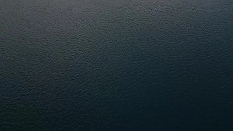 Aerial view of the sea surface pattern reflecting the sky background Video stock 258565682