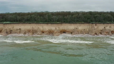 Aerial view of sea waves beating against a rocky shore on a sandy tropical beach Stock-Footage 156052960