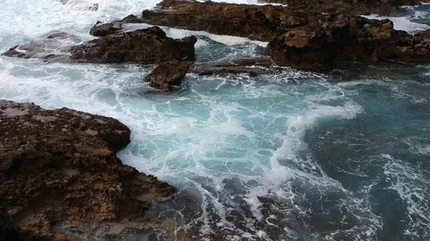 Aerial view from Sea waves crashing against the rocks Stock Footage 88409299