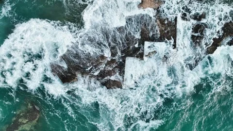 Aerial view of sea waves hitting the rocks with drone Stock Footage 255612963