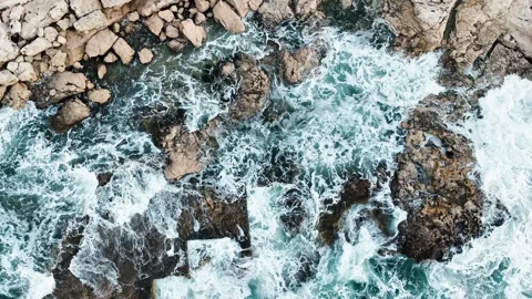 Aerial view of sea waves hitting the rocks with drone Stock Footage 255613069