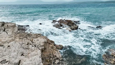 Aerial view of sea waves hitting the rocks with drone Stockbeeldmateriaal 255613092