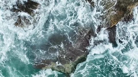 Aerial view of sea waves hitting the rocks with drone Stock Footage 255613130