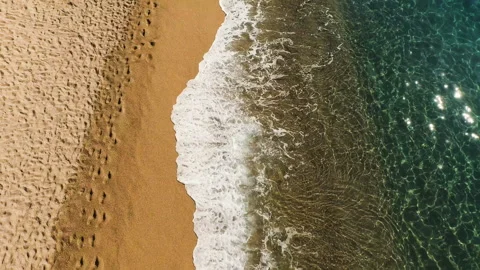 Aerial view of sea waves of reaching shore with yellow sandy. Video stock 88654130