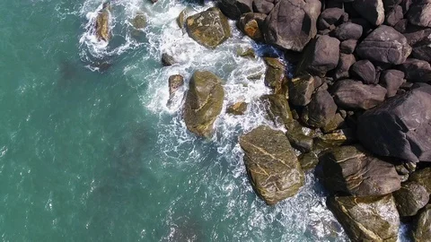 Aerial view of sea waves reaching black stones beach 스톡 동영상 107697705