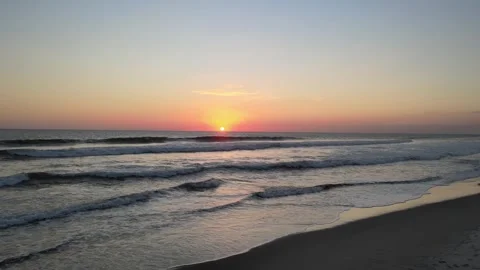 Aerial View of Sea Waves at Sunset on a Sandy Beach. Видео 341830474