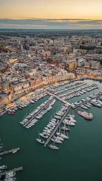 Aerial view of seafront and old town Bisceglie in Puglia with drone on sunset. Stock Photos