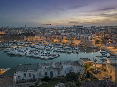 Aerial view of seafront and old town Bisceglie in Puglia with drone on sunset. Stock Photos