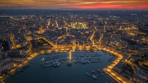 Aerial view of seafront and old town Bisceglie in Puglia with drone on sunset. Stock Photos