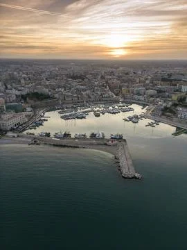 Aerial view of seafront and old town Bisceglie in Puglia with drone on sunset. Stock Photos