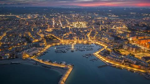 Aerial view of seafront and old town Bisceglie in Puglia with drone on sunset. Stock Photos