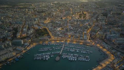 Aerial view of seafront and old town Bisceglie in Puglia with drone on sunset. Stock Photos