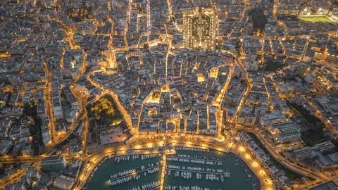 Aerial view of seafront and old town Bisceglie in Puglia with drone on sunset. Stock Photos