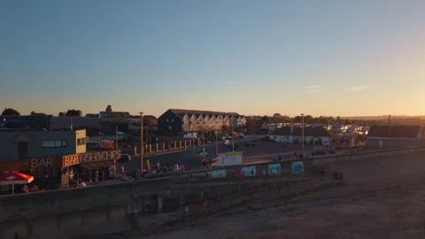Aerial View of Seafront Bar and Village During Partial Solar Eclipse Stockbeeldmateriaal 345115853