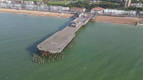 Aerial view of the seafront, beach and pier at Hastings Stock Footage 242913652