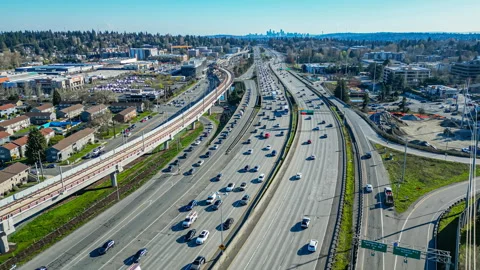 Aerial view of a Seattle freeway with a view of the city skyline in the distance Stock Footage 273175449