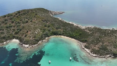 Aerial view of secluded turquoise bay with boats, Halkidiki, Greece Stock Footage 327722641
