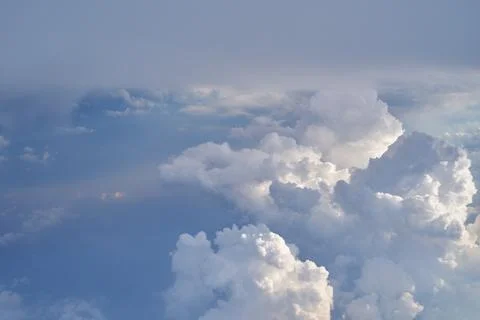 Aerial view seen over clouds, from modern aircraft at daytime. Stock Photos