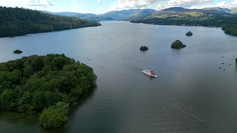 Aerial view of a serene lake with distant hills and small islands Stock Footage 345522321