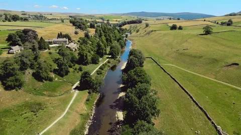 Aerial view of a serene river through lush green countryside. Yorkshire Dal.. Stock Footage 346283773