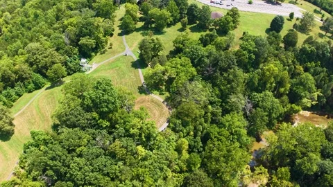 An aerial view of a serpent mound with greenery and paths in Chillicothe, Ohio. Stock Footage 336508854