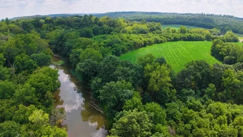 Aerial view of a serpent mound surrounded by lush greenery and rivers. Stock Footage 336508955