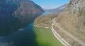 Aerial view of serpentine railroad at mountain bottom, beautiful lake, tourism 4k or 4k+ Resolution