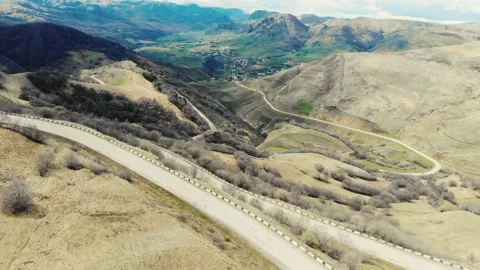 Aerial view of serpentine road between incredible Caucasus Mountains. Panoramic Stock Footage 157583006